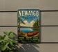 A vintage-style metal sign for Newaygo State Park, Michigan, featuring a canoe on a lake surrounded by trees and mountains.