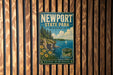 A vintage-style metal sign for Newport State Park in Wisconsin, featuring a scenic landscape with a lake, cliffs, and a sailboat.