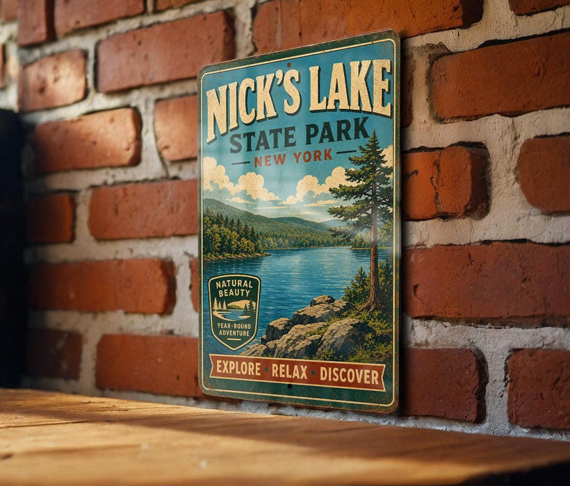 A vintage-style metal sign for Nick's Lake State Park in New York, featuring a scenic landscape with a lake, mountains, and pine trees.