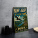 A vintage-style sign for Nine Eagles State Park in Iowa, featuring an eagle in flight and a scenic landscape.