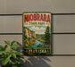 A vintage-style metal sign for Niobrara State Park in Nebraska, featuring a scenic landscape with a river, mountains, and wildflowers.