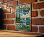 A vintage-style metal sign for Nockamixon State Park in Pennsylvania, featuring a scenic illustration of a lake, sailboat, and mountains.