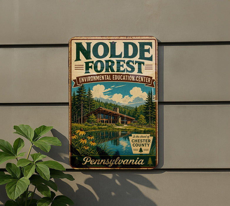 A vintage-style sign for the Nolde Forest Environmental Education Center in Pennsylvania, featuring a scenic image of a cabin surrounded by trees and a lake.