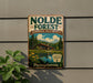 A vintage-style sign for the Nolde Forest Environmental Education Center in Pennsylvania, featuring a scenic image of a cabin surrounded by trees and a lake.