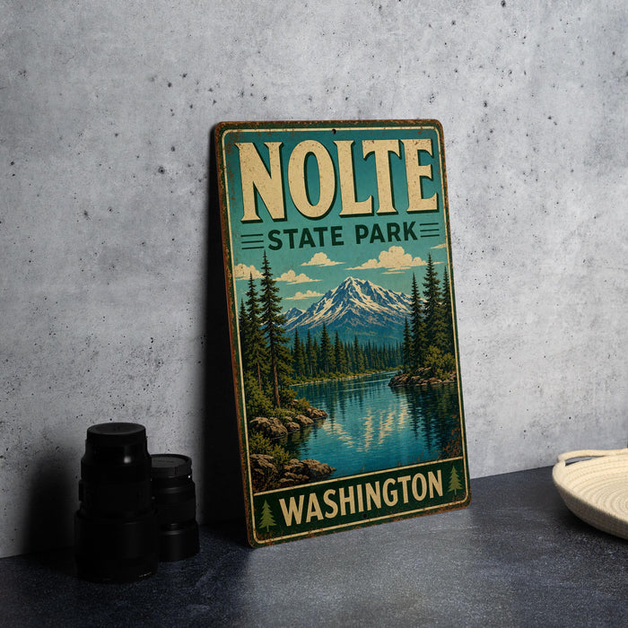 A vintage-style metal sign for "NOLTE STATE PARK" in Washington, featuring a scenic landscape with a mountain, lake, and pine trees.