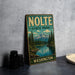 A vintage-style metal sign for "NOLTE STATE PARK" in Washington, featuring a scenic landscape with a mountain, lake, and pine trees.