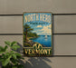 A vintage-style metal sign for North Hero State Park in Vermont, featuring a scenic landscape with a sailboat on the water.
