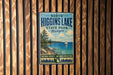 A vintage-style metal sign for North Higgins Lake State Park in Michigan, featuring a scenic image of the lake and surrounding landscape.