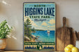A vintage-style metal sign for North Higgins Lake State Park in Michigan, featuring a scenic image of a lake with a sailboat and pine trees.
