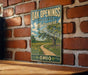 A vintage-style sign for Oak Openings Preserve Metropark in Ohio, featuring a scenic landscape with a winding path and a tree.