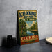 A vintage-style metal sign for Ochlockonee River State Park in Florida, featuring a tropical landscape with palm trees and a river.
