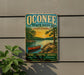 A vintage-style metal sign for Oconee State Park in South Carolina, featuring a scenic illustration of a lake, trees, and a canoe.