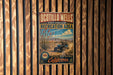 a vintage-style metal sign for Ocotillo Wells State Vehicular Recreation Area, with a desert landscape and a blue off-road vehicle.