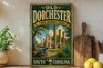 a vintage-style sign for Old Dorchester State Historic Park in South Carolina, with a painting of a cannon and ruins in the background.