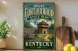 A vintage-style sign for Old Fort Harrod State Park in Kentucky, featuring a wooden fort and a path leading to the entrance.