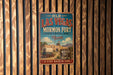 A vintage-style metal sign for the Mormon Fort in Las Vegas, Nevada, featuring a wagon and a building in the background.