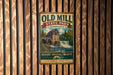 a vintage-style metal sign for Old Mill State Park in Minnesota, with a scenic illustration of a waterfall and a building.