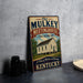 A vintage-style sign for the Old Mulkey Meetinghouse, a historic site in Kentucky, featuring a photograph of the building and the text "Old Mulkey Meetinghouse State Historic Site" and "A Place of Worship and Heritage Kentucky".