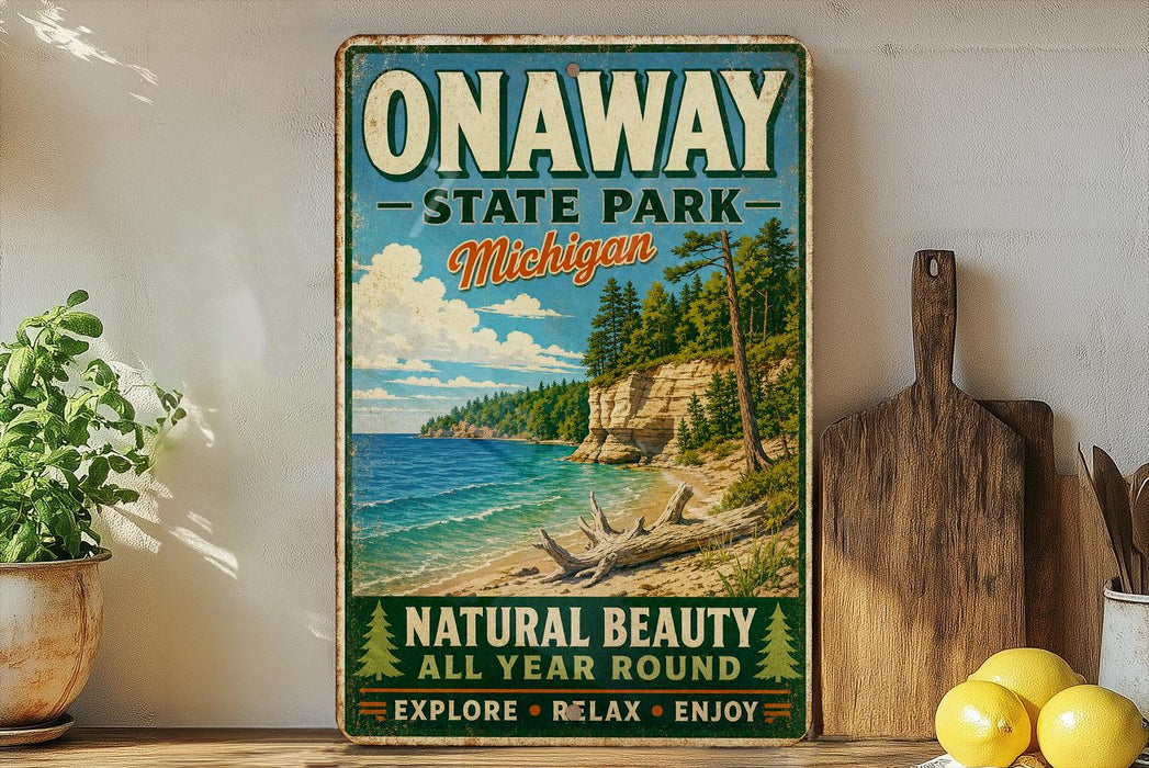A vintage-style sign for Onaway State Park in Michigan, featuring a scenic beach landscape with pine trees and a cliff overlooking the water.