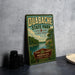 A vintage-style metal sign for Quabache State Park in Indiana, featuring a scenic landscape with a lake and trees.