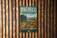 A vintage-style metal sign for Pacheco State Park in California, featuring a scenic landscape with a path, trees, and a body of water.