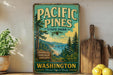A vintage-style sign for Pacific Pines State Park in Washington, featuring a scenic landscape with pine trees, a beach, and mountains.