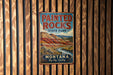 A vintage metal sign for Painted Rocks State Park in Montana, featuring a scenic landscape with mountains and a river.