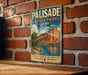 A vintage-style metal sign for Palisade State Park in Utah, featuring a scenic illustration of a mountain landscape with a lake in the background.