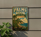 A vintage metal sign for Palm Book State Park in Michigan, featuring a tropical beach scene with palm trees and a body of water.