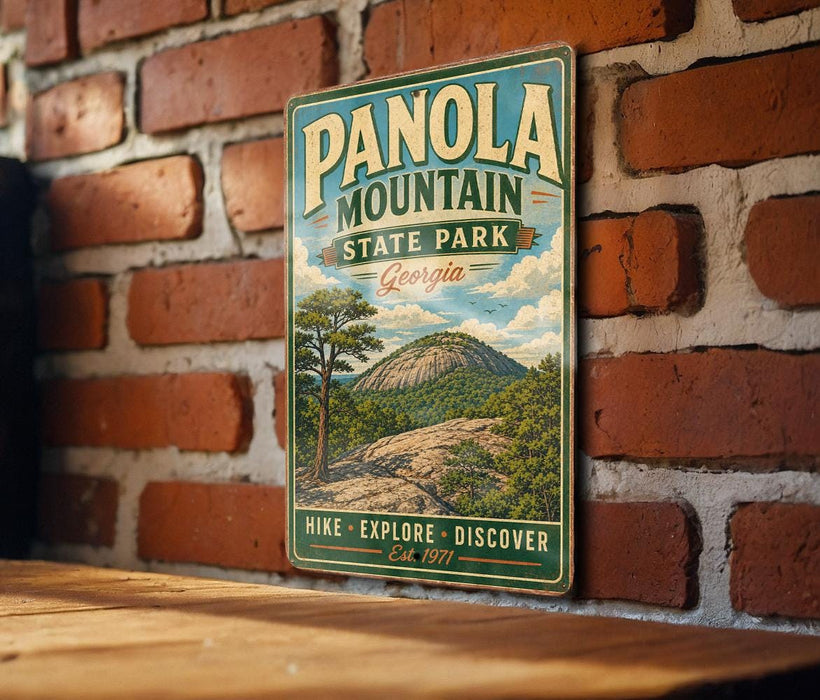 A vintage-style metal sign for Panola Mountain State Park in Georgia, featuring a scenic illustration of a mountain landscape.
