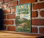A vintage-style metal sign for Panola Mountain State Park in Georgia, featuring a scenic illustration of a mountain landscape.
