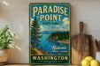 A vintage-style sign for Paradise Point State Park in Washington, featuring a scenic landscape with a mountain, pine trees, and a lake.