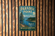 A vintage-style metal sign for Paradise Point State Park in Washington, featuring a scenic mountain landscape and a pine tree.