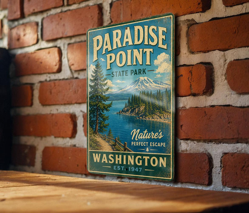 A vintage-style metal sign for Paradise Point State Park in Washington, featuring a scenic mountain landscape and a lake.