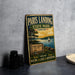 A vintage-style metal sign for Paris Landing State Park in Tennessee, featuring a scenic illustration of the park with a lake, sailboat, and trees.