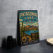 A vintage-style metal sign for Patagonia Lake State Park in Arizona, featuring a desert landscape with a cactus, mountains, and a lake.