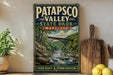 A vintage-style metal sign for Patapsco Valley State Park, Maryland, featuring a scenic landscape with a bridge over a river.