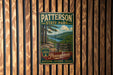 A vintage metal sign for Patterson State Park, featuring a scenic landscape with pine forests, mountains, and a river.