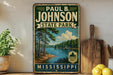 A vintage-style metal sign for Paul B. Johnson State Park in Mississippi, featuring a scenic landscape with a lake and trees.