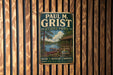 A vintage metal sign for Paul M. Grist State Park, featuring a scenic illustration of a lake, cabin, and trees.