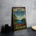 A vintage metal sign for Pawtuckaway State Park, featuring a canoe and a scenic landscape, is displayed on a gray countertop.
