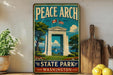 A vintage-style metal sign for Peace Arch State Park in Washington, featuring an illustration of the monument surrounded by trees, flowers, and a body of water.