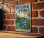 A vintage-style sign for the state park of Florida, featuring a peacock and a scenic landscape.
