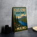 A vintage-style metal sign for Peaks- Kenny State Park in Maine, featuring a scenic landscape with pine trees, mountains, and a lake.