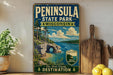 A vintage-style poster for Peninsula State Park in Wisconsin, featuring a scenic landscape with a lake, mountains, and a cave.