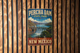 A vintage-style poster for Percha Dam State Park in New Mexico, featuring a scenic waterfall and mountains in the background.