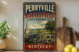 A vintage-style metal sign for Perryville Battlefield, a State Historic Site in Kentucky, featuring an illustration of a cannon and a landscape with a bridge.