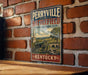 A vintage-style metal sign for Perryville Battlefield, a state historic site in Kentucky, is displayed on a brick wall.