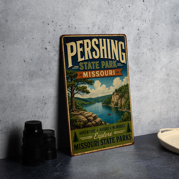 A vintage metal sign for Pershing State Park in Missouri, featuring a scenic landscape with a lake, mountains, and a tree.