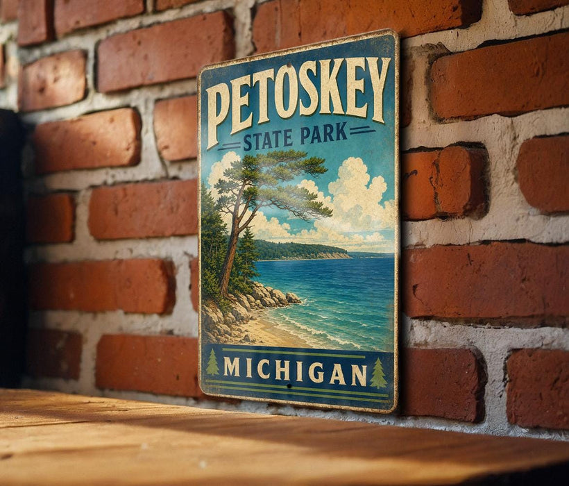 A vintage-style metal sign for Petoskey State Park in Michigan, featuring a scenic landscape with a pine tree, a lake, and mountains.